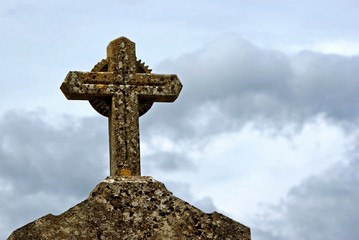 Stone cross on gravestone a cemetery in France.