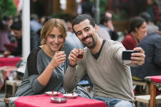 Turkish Couple Taking Selfie while Drinking Cay, Traditional Tea
