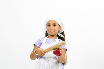 Small smiling chef with kitchen utensils and strawberry