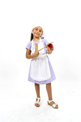 Small smiling chef with kitchen utensils and strawberry