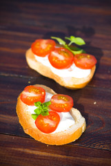 Italian tomato bruschetta with cheese and basilik 