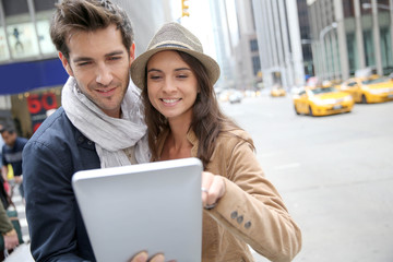 Couple looking at New York city tourist information on tablet
