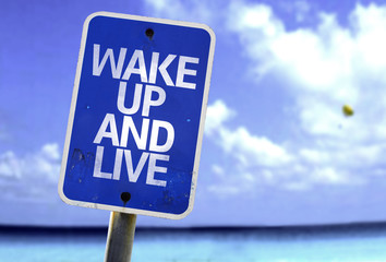 Wake Up and Live sign with a beach on background