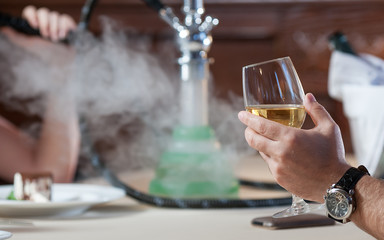 man and woman smoking hookah