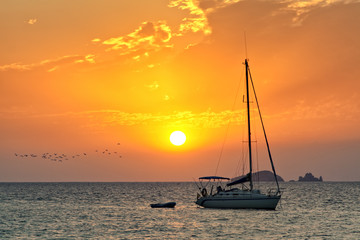 Sailboat in sunset off Ibiza coast