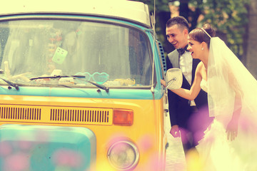Bride and groom near a van