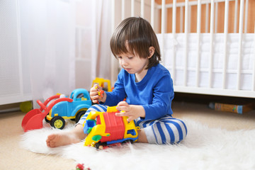 little boy plays cars