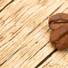 Roasted coffee beans on wooden table - view from top