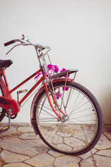Fototapeta na wymiar classic old bicycle decorated with pink flower
