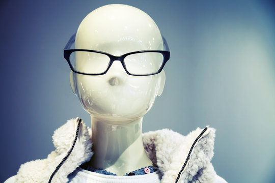 Portrait of white dummy wearing glasses in the clothing store