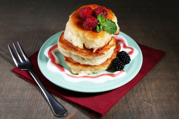 Tasty pancakes with fresh berries and mint leaf