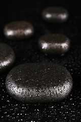 Spa stones with drops isolated on black