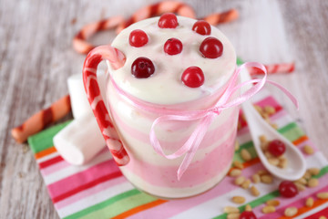 Raspberry milk dessert in glass jar,