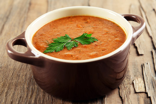 Delicious lentil cream-soup on table close-up