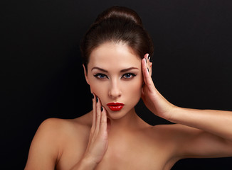 Sexy makeup female model posing with hand near face