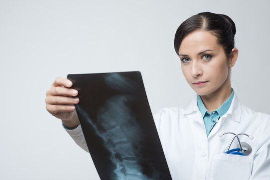 Female radiologist checking x-ray image