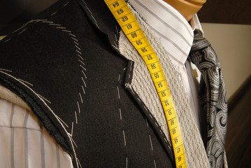 Tailor shop mannequin with measuring tape.