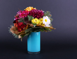 Flower bouquet in blue vase on dark grey background