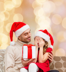 smiling daughter waiting for present from father