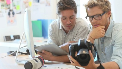 Journalist and reporter working together in agency
