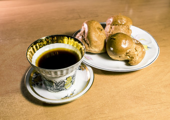 Black coffee and cake on the plate
