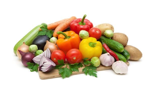 fresh vegetables on cutting board on white background