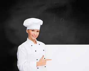 smiling female chef with white blank board