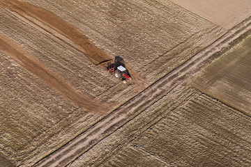 aerial view of harvest fields with tractor