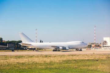 Fototapeta na wymiar Big Cargo Airplane at Airport Parking Area