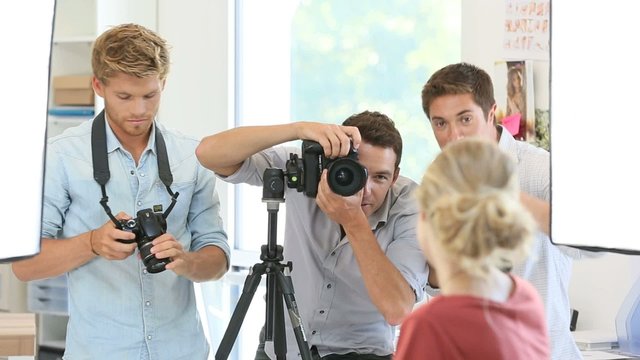 Model being photographed by students in photography