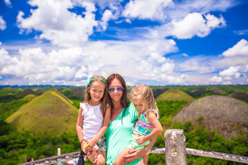 Little cute girls and mother on background of the Chocolate