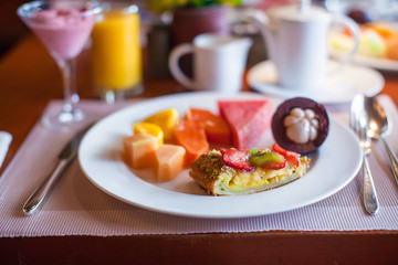 Healthy breakfast with juicy fruits and black coffee