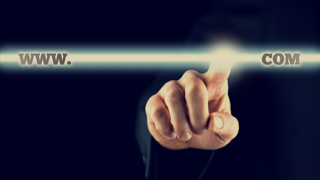 Businessman activating a www.com button on virtual screen