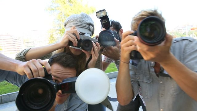 Group of paparazzi people taking picture 