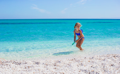 Adorable little girl have fun at tropical beach