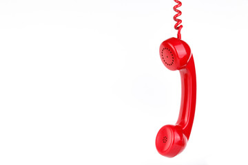 Classic red phone on white background.