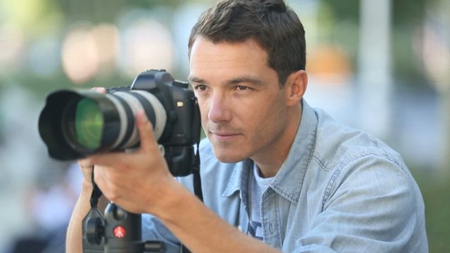 Photographer using reflex camera outside