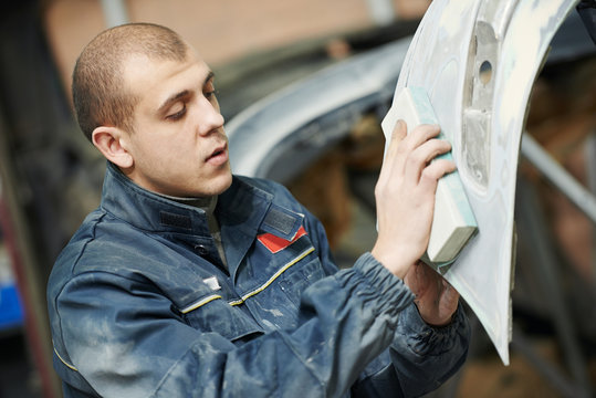 auto mechanic polishing car