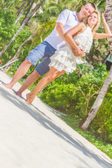 Naklejka na ściany i meble young loving couple on tropical island, outdoor wedding ceremony