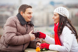 Romantic young couple drinking mulled wine