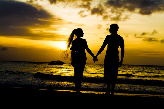 young couple on wedding day in sunset sea and sky background