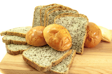 The cut loaf of bread with wood isolated on white .