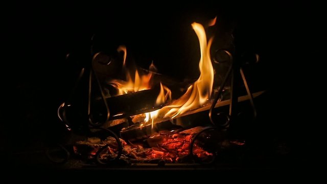 close up of fireplace and wood burning slow motion