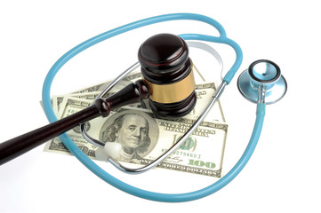Stethoscope with judge gavel, money isolated on white