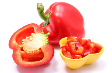 Chopped, whole and half of fresh peppers on white background