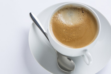 Cup of coffee on a white plate on white background