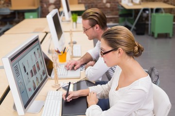 Concentrated casual photo editors using digitizer in office