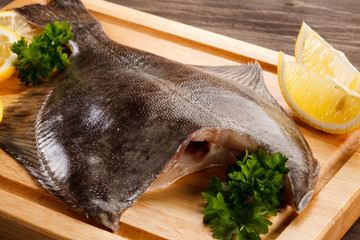 Fresh raw flounder on cutting board