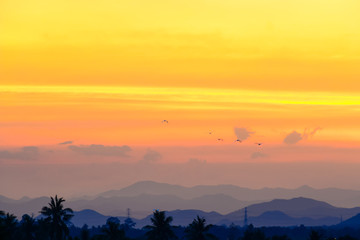 Sun set among mountain with orange warm colour.