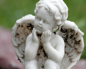 sweet angelic figurine isolated on green and pink background